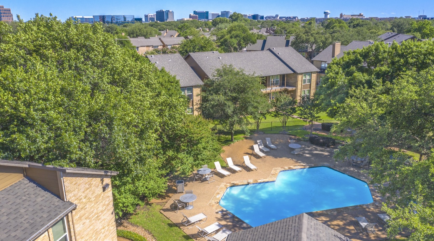 Relax and unwind poolside aerial view of a swimming pool and a city in the background