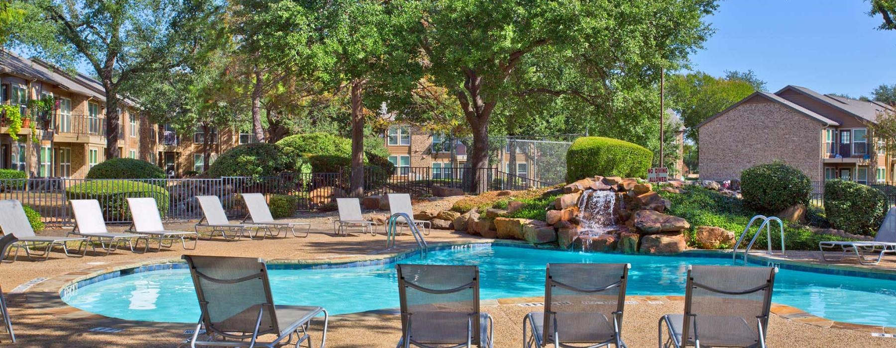 a pool with chairs around it