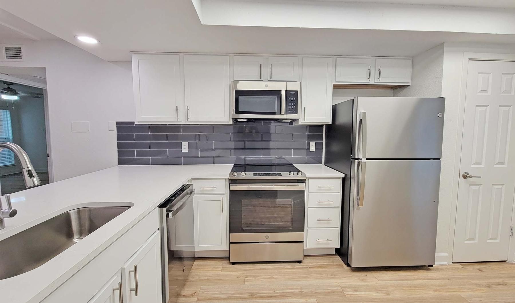 Settle into comfort at Communities of Bent Tree a kitchen with white cabinets