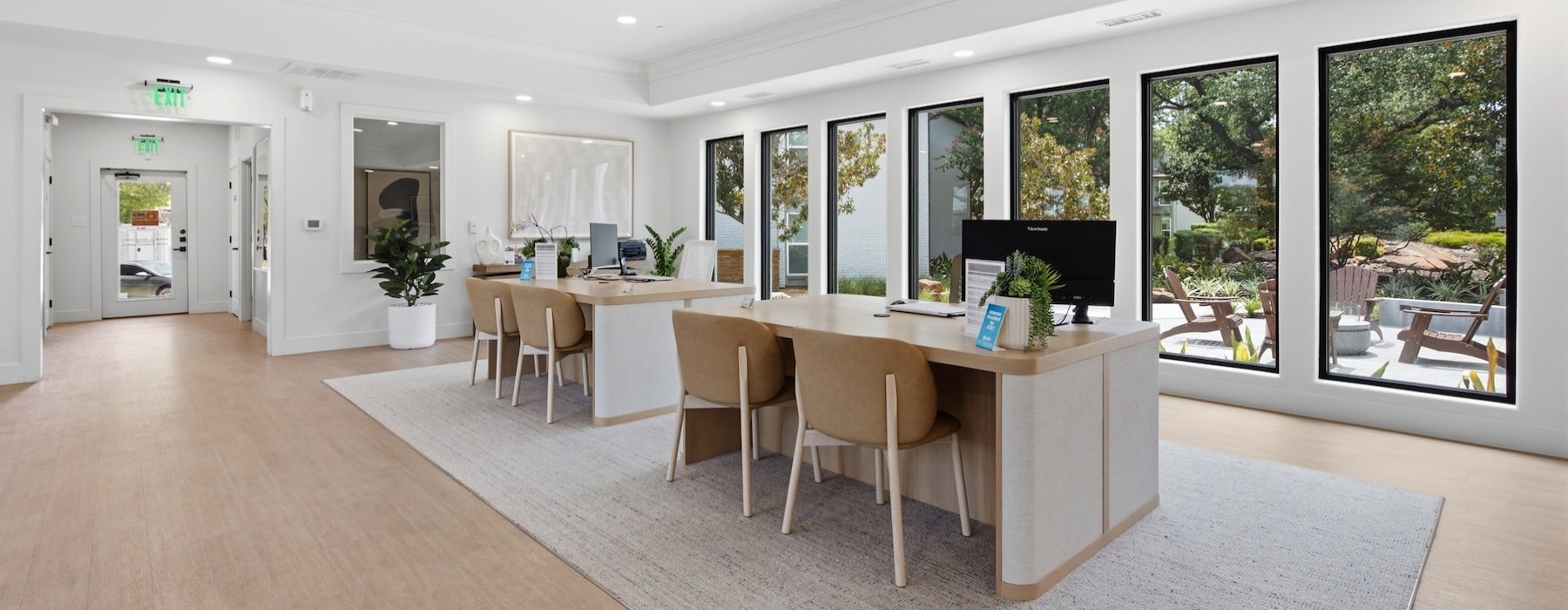 a room with computers in desks with chairs