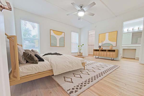 Bedroom with new LED lit ceiling fan and nice hardwood floors.